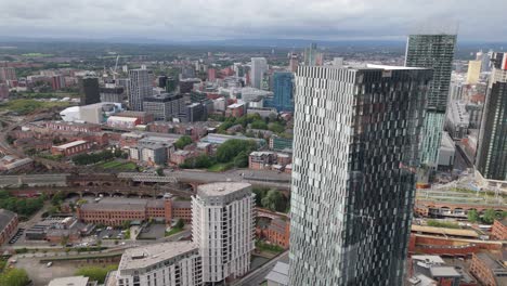 Deansgate-Square-luxury-apartment-towers-in-Manchester,-aerial-tilt-down-riser