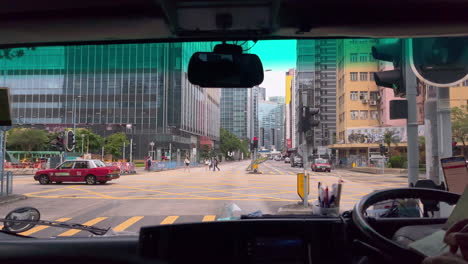 Pov-of-passengers-in-a-car-as-it-stops-at-a-red-light-intersection-on-a-highway-in-Hong-Kong