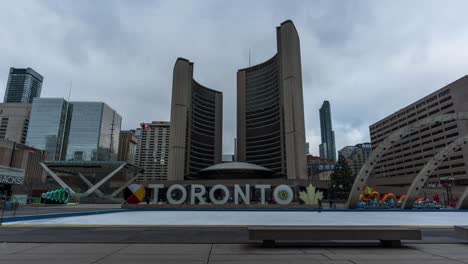 Tourists-And-Ice-Skaters-Visiting-Toronto-City-Hall-In-Winter,-Time-Lapse