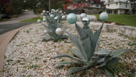 Christmas-ornament-decoration-baubles-on-agave-plants-in-Texas-neighborhood,-slow-motion