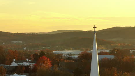 Birds-Perch-On-Cross-Atop-Church-Steeple-On-An-Autumn-Morning-In-Fayetteville,-Arkansas