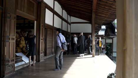 Visitors-On-Veranda-At-Ryoanji-Temple-Taking-Photos-Of-The-Hojo