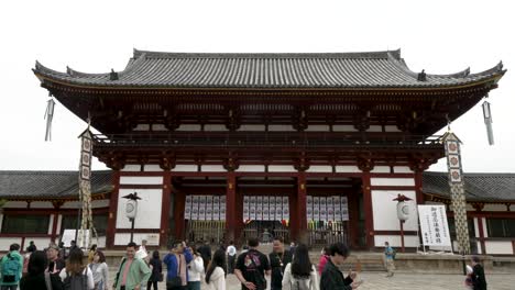 Tourists-walking-around-the-main-central-entrance-of-the-Todai-ji-Chumon-at-Nara