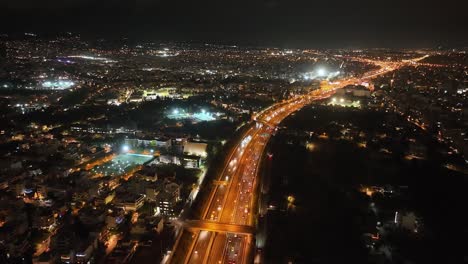Drone-flight-over-an-urban-highway-at-night