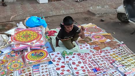 A-young-boy-is-selling-decorative-items-on-the-street-road-to-earn-his-livelihood
