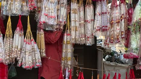 A-shopkeeper-is-arranging-garlands-for-offering-to-God-in-his-shop