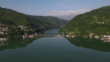 Aerial-drones-fly-over-the-canyon-of-jablanica-lake,-bridge-connecting-the-river