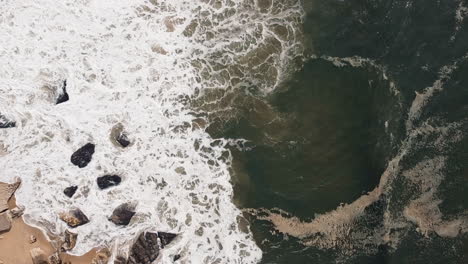 Foamy-waves-at-Nazaré,-Portugal-from-above.-Aerial