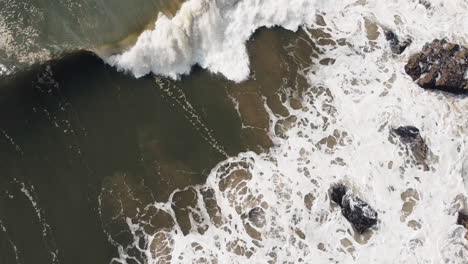 Crashing-wave-on-Nazaré,-Portugal-shoreline.-Aerial-topview