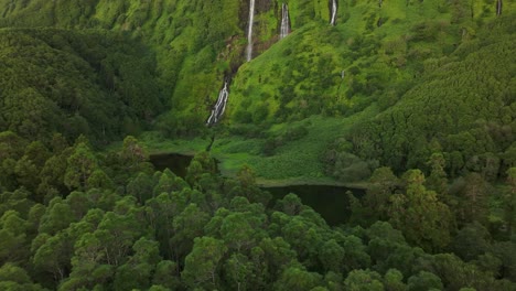 Wide-view-of-waterfall-Poço-Ribeira-do-Ferreiro-in-Flores-island---Drone-shot