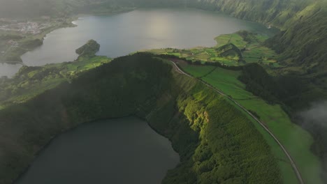 Flying-above-famous-Lagoa-das-Sete-Cidades-with-low-clouds-at-sunset---drone-shot
