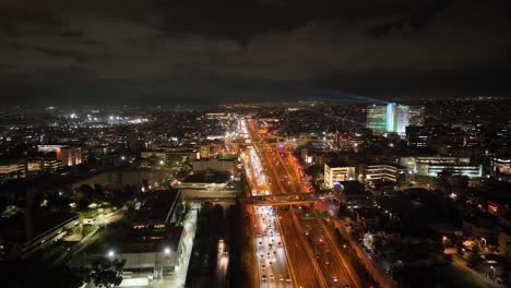 Aerial-footage-of-an-urban-highway-with-traffic-at-night