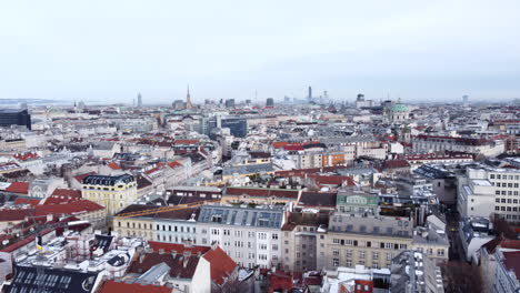 Aerial-flying-backwards-over-buildings-of-Vienna-old-town,-Austria