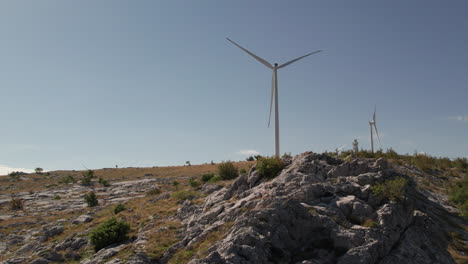 Wind-Turbine-showing-up-behind-a-mountain