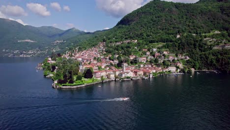 Static-aerial-landscape-of-boat-cruising-past-Torno,-Lake-Como,-Italy