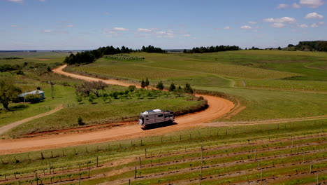 Aerial-Shot-Expedition-Truck-Driving-Sand-Track-Uruguay-Brazil-Border-Vineyard-Green-Landscape