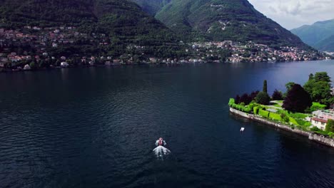 Aerial-tracking-small-tourist-speed-boat-on-Lake-Como,-Italy