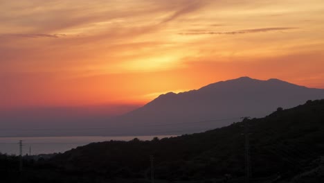Sun-setting-behind-the-mountains-near-Marbella,-Spain