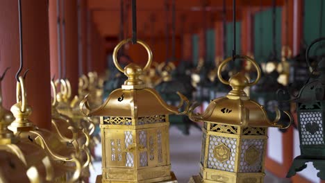 Hanging-Kasugasha-inscribed-gold-lanterns-at-Kasuga-taisha-shrine-in-Nara,-Japan