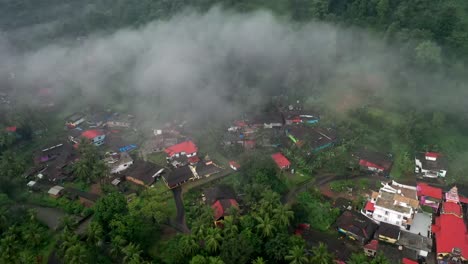 AERIAL-DRONE-VIEW-There-are-many-coconut-groves-around-the-big-houses-in-the-middle-of-the-mountains