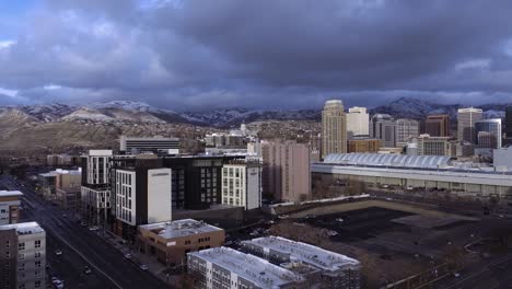 Salt-Lake-City,-Utah-skyline-at-twilight-in-winter---push-in-aerial-flyover