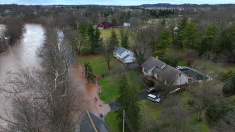 Ascending-drone-shot-of-flooded-river-in-american-countryside-after-strong-rain-at-night---Lancaster,-Pennsylvania,-America
