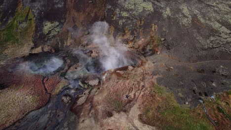 Cloudy-Steams-In-Geothermal-Area-Near-Reykjadalur-In-South-Iceland,-aerial-orbit
