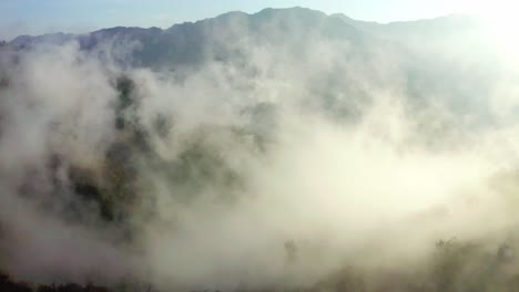aerial-drone-camera-cinematic-shot-The-drone-is-moving-through-the-camera-where-the-hills-are-visible-due-to-the-fog-not-aerial-drone-camera-cinematic-shot-Clouds-are-visible