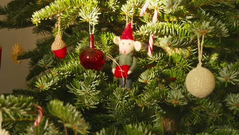 Scandi-Style-Decorated-Christmas-tree-with-colorful-ornaments-and-festive-mouse-figure-on-daytime