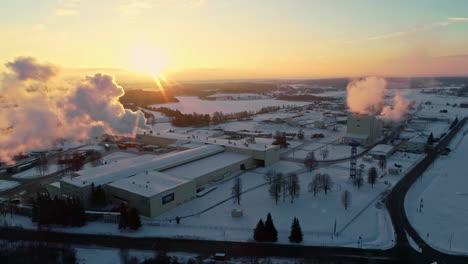 District-heating-plant-in-winter-at-sunset---aerial-parallax