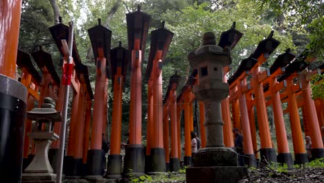 Atracción-Turística-Ocupada-Puertas-Torii-Fushimi-Inari-Rojas-Y-Gente-Caminando-En-Kyoto,-Japón