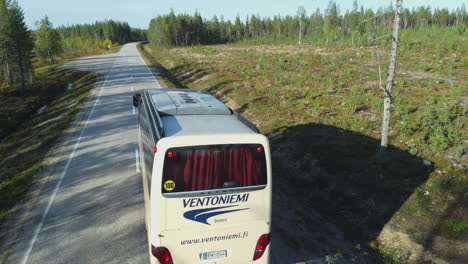 Aerial-camera-chases-Ventoniemi-tour-bus-in-rural-boreal-Finland-bush
