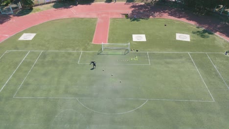 AERIAL-SHOT-GOALKEEPER-TRAINING-ON-THE-COURT-IN-THE-AFTERNOON