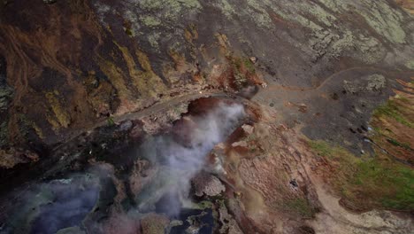 Flying-over-Steam-Valley-and-Geothermal-Hot-Springs-along-the-Reykjadalur-in-Iceland,-Aerial