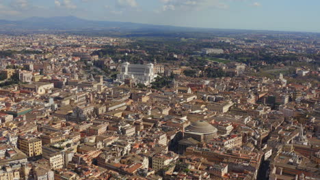 Aerial-view-of-Rome-with-3-iconic-landmarks-Pantheon,-Victor-Emmanuel-II-Monument-and-Colosseum,-Italy