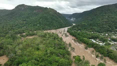 Views-of-the-overflowing-Barron-River-and-surrounding-suburb-Caravonica-after-heavy-rains,-Cairns