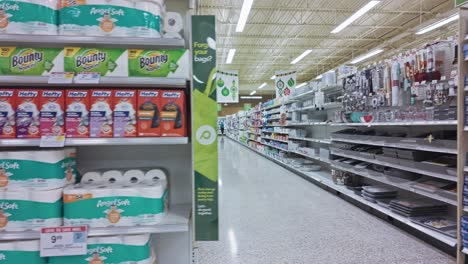 Panning-shot-showing-lines-inside-supermarket-with-wine,-washing-powder-and-bathroom-tissue