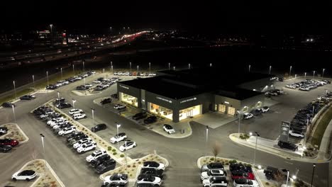 Nighttime-aerial-view-of-a-Jaguar-and-Land-Rover-car-dealership-hear-a-highway