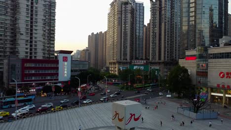Aerial-view-of-downtown-square-with-skyscrapers-and-congested-traffic-in-Chongqing,-China