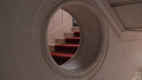 Slow-orbiting-shot-of-stairs-through-a-window-within-a-Chateau-de-Pouzilhac