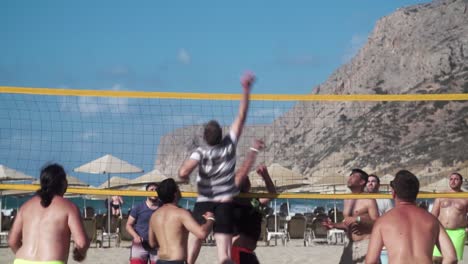 Group-of-Guys-Playing-Beach-Volleyball-in-Crete,-Slow-Motion