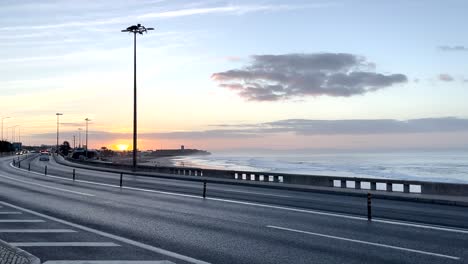 Wide-shot-of-scenic-car-road-in-Portugal,-next-to-a-Atlantic-ocean