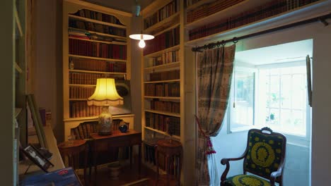 Slow-revealing-shot-of-a-home-library-with-antique-books-in-the-shelf