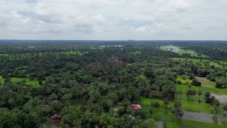 Lush-Cambodian-Farmland-Gives-Way-To-Temple-Ruins-In-The-Distance