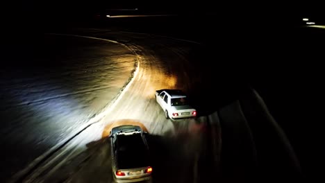 Extreme-aerial-follow-of-drifting-cars-in-racetrack-during-winter-night