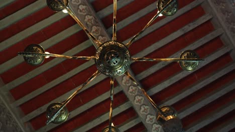 Rotating-shot-showing-an-antique-chandelier-hanging-inside-Chateau-de-Pouzilhac