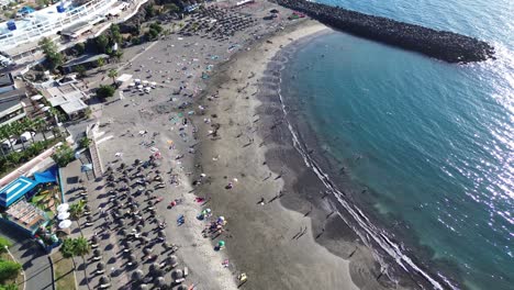 Holiday-destination-beach-in-Los-Cristianos,-Tenerife-Canary-Islands-Spain-aerial-view