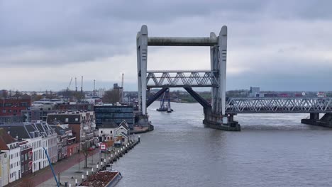 Truss-steel-railway-bridge-opening,-floating-crane-and-escort-vessel