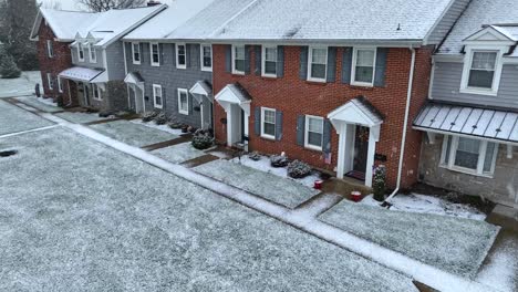 American-USA-flag-on-brick-homes-during-winter-snow
