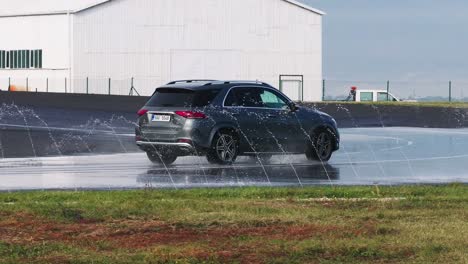 Brand-new-Mercedes-SUV-drive-on-wet-asphalt-safe-driving-school-track